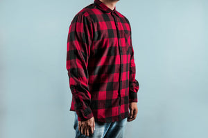 Chequered Red Shirt featuring bold buffalo plaid pattern in red and black, with long sleeves and dual chest pockets, shown against light blue background, classic flannel design with button-up front